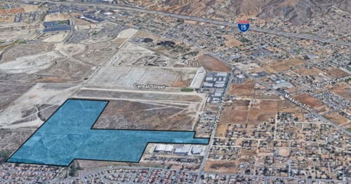 Aerial view of a semi-urban area with a large, irregular blue-outlined plot of land adjacent to Cereal Street and Corydon Road, near Interstate 15.